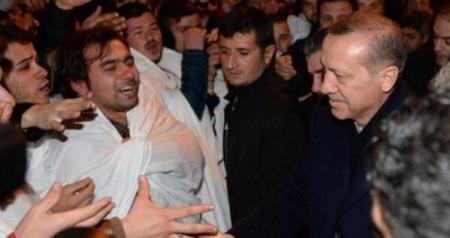 PM Erdogan greeted by followers wearing shrouds saying they'll die for him.
